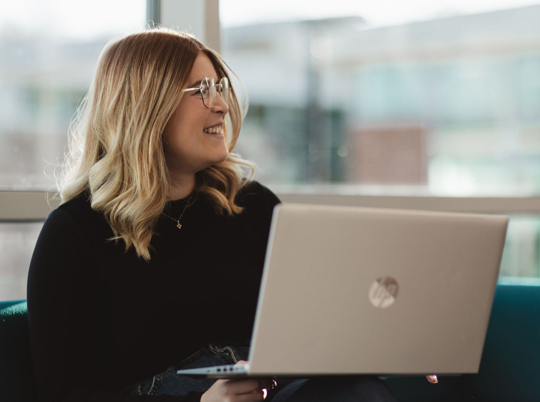 Onecom employee holding laptop