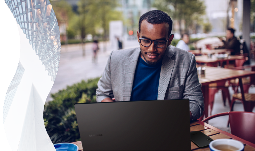 Man working on laptop at cafe