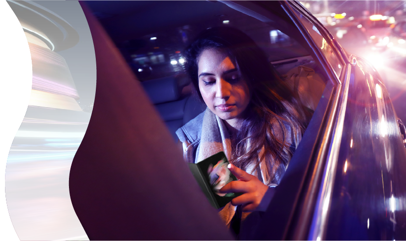 Lady on mobile phone in backseat of car