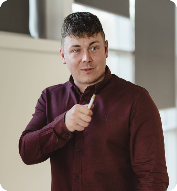 Onecom employee in shirt talking with pen in hand